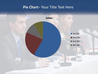 A Group Of People Sitting At A Table With Microphones PowerPoint Template