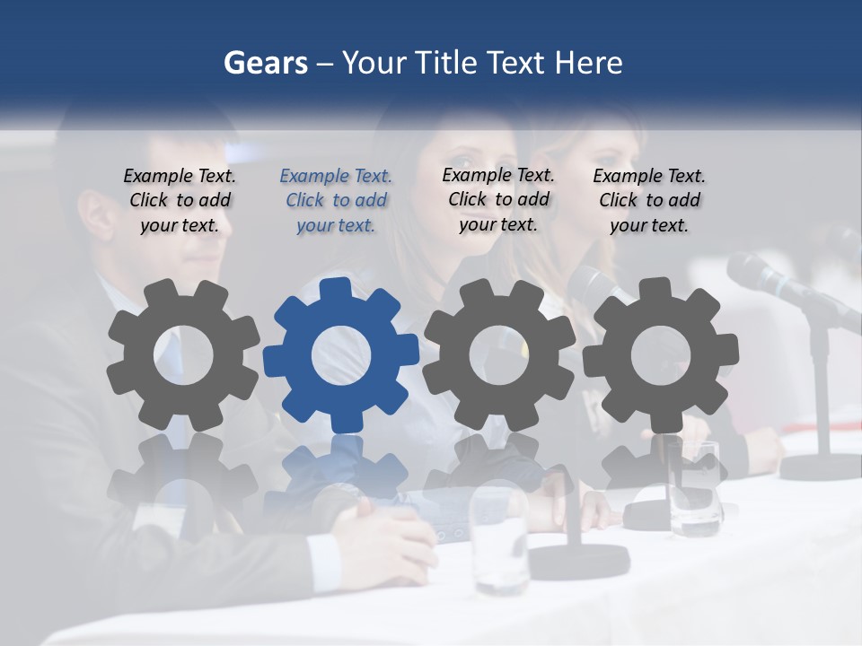 A Group Of People Sitting At A Table With Microphones PowerPoint Template