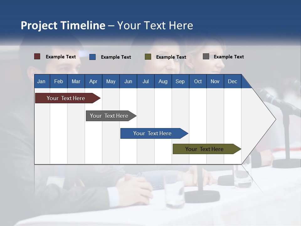 A Group Of People Sitting At A Table With Microphones PowerPoint Template
