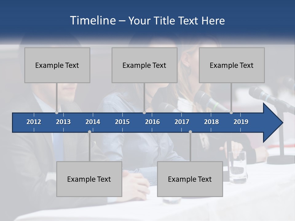 A Group Of People Sitting At A Table With Microphones PowerPoint Template