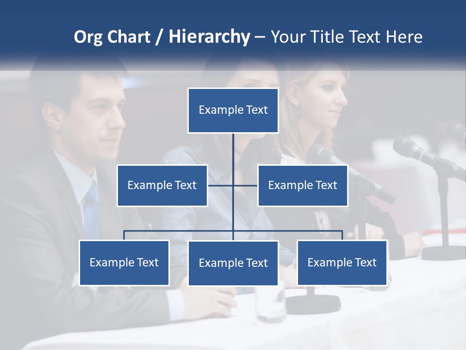 A Group Of People Sitting At A Table With Microphones PowerPoint Template