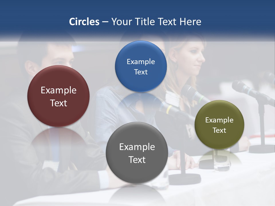 A Group Of People Sitting At A Table With Microphones PowerPoint Template