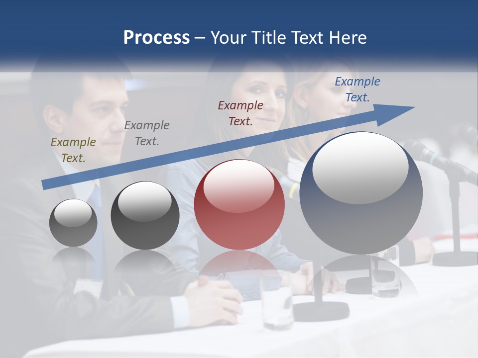 A Group Of People Sitting At A Table With Microphones PowerPoint Template