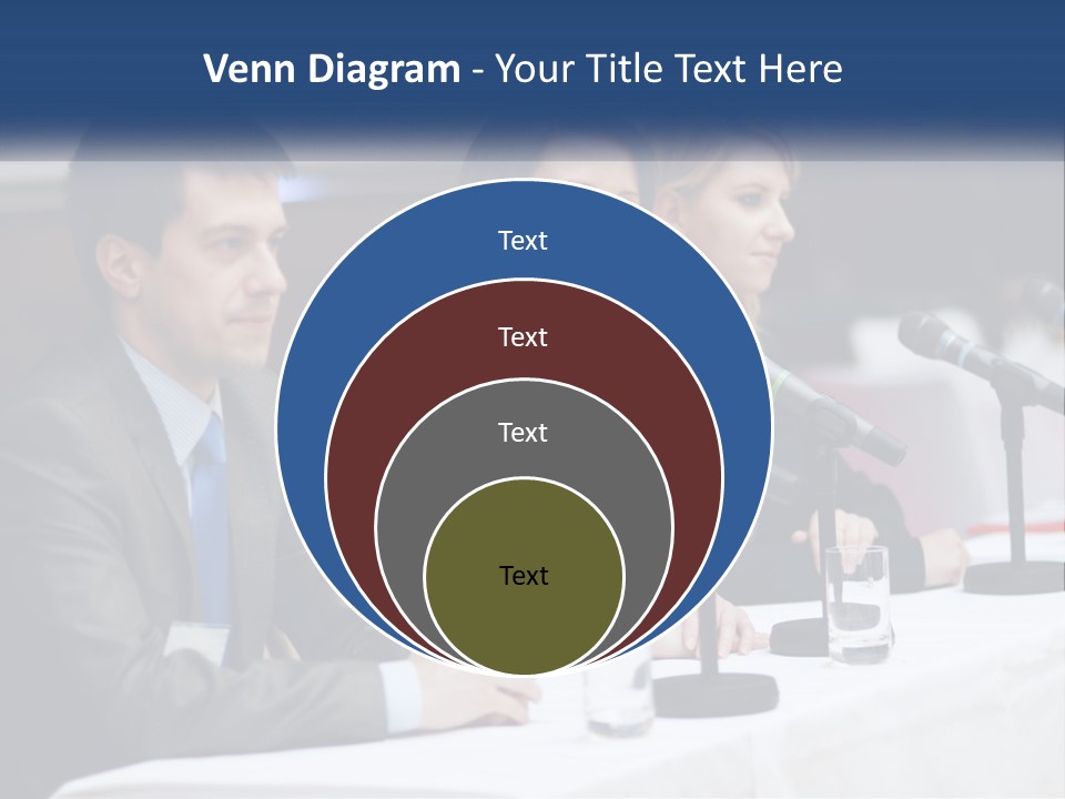 A Group Of People Sitting At A Table With Microphones PowerPoint Template