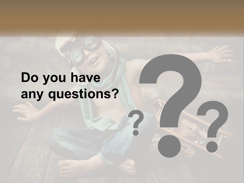 A Young Boy In A Hat And Scarf Sitting On A Wooden Floor PowerPoint Template
