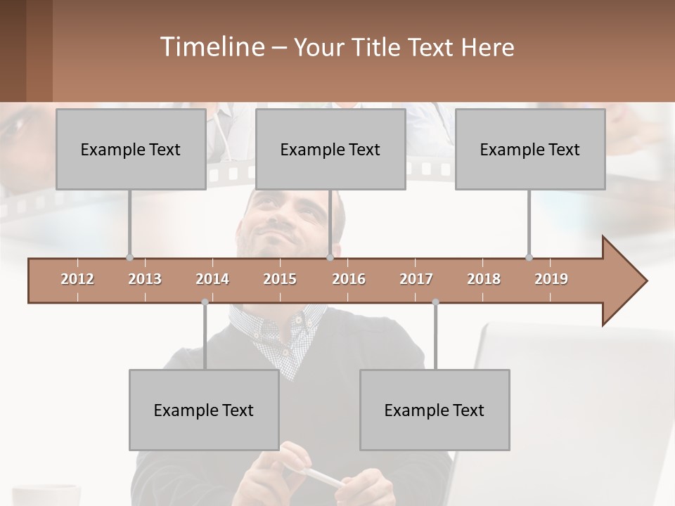 A Man Sitting In Front Of A Laptop Computer PowerPoint Template