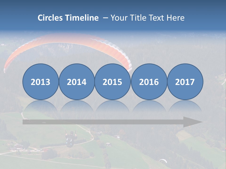 A Person Paragliding Over A Lush Green Hillside PowerPoint Template