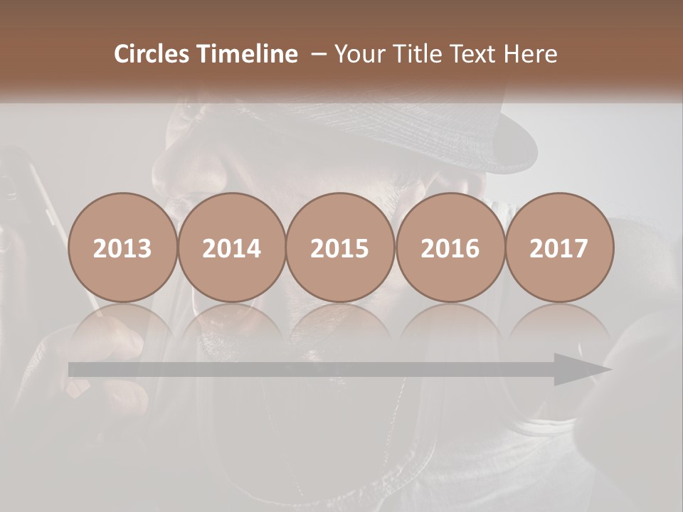 A Man In A Hat Holding A Cell Phone PowerPoint Template