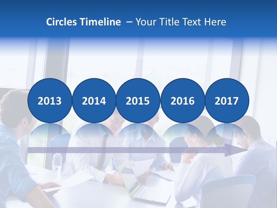 A Group Of People Sitting Around A Table Talking PowerPoint Template