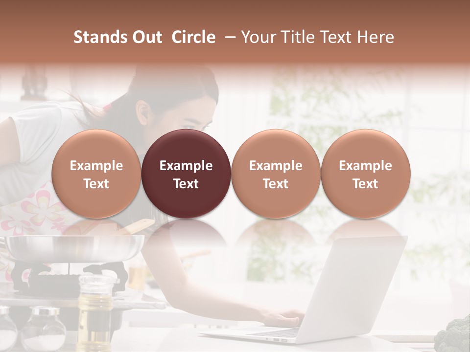 A Woman Using A Laptop On A Kitchen Counter PowerPoint Template