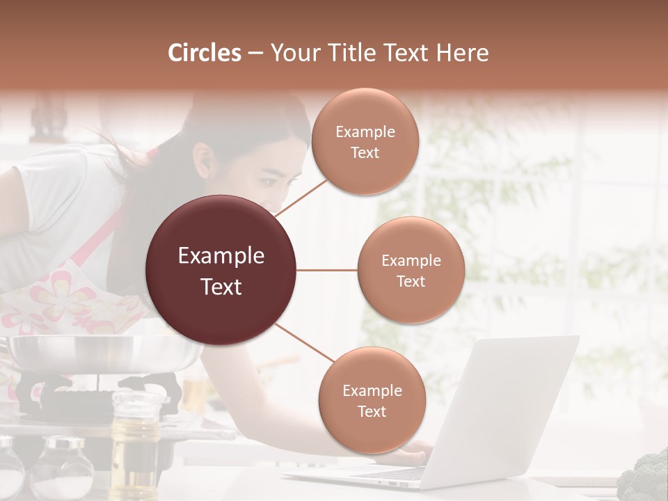 A Woman Using A Laptop On A Kitchen Counter PowerPoint Template