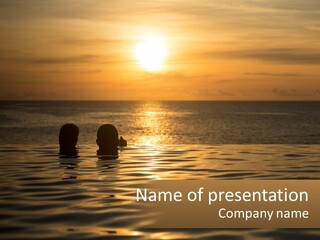 Two People In The Water At Sunset Powerpoint Template PowerPoint Template
