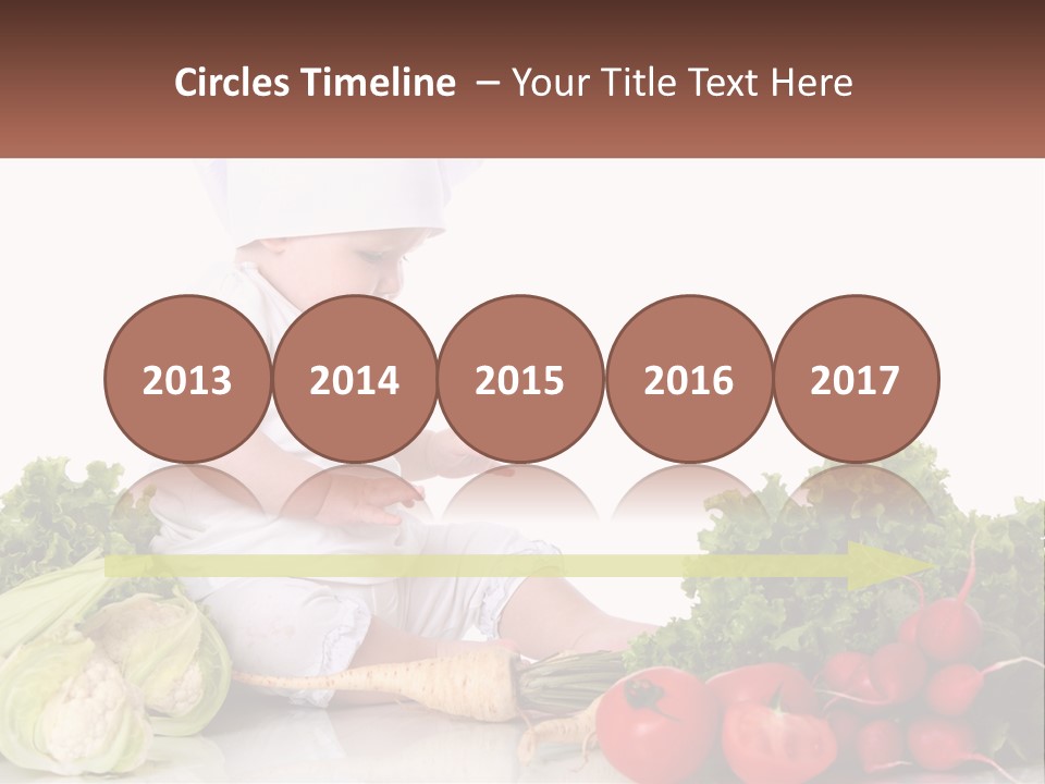 A Baby In A Chef's Hat Sitting On A Table Surrounded By Vegetables PowerPoint Template