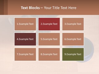 A Cat Sitting Next To A Blue Bowl On A Wooden Floor PowerPoint Template