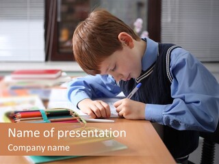 A Young Boy Writing On A Piece Of Paper PowerPoint Template