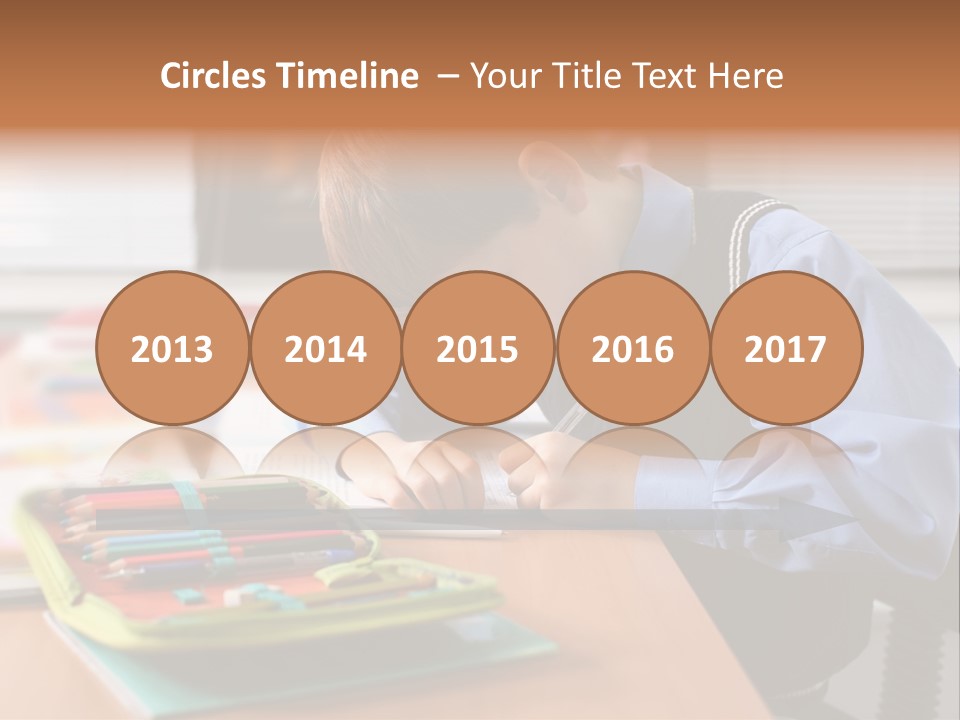 A Young Boy Writing On A Piece Of Paper PowerPoint Template