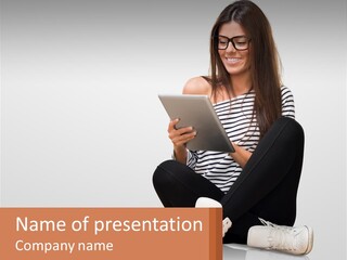 A Woman Sitting On The Floor Using A Tablet PowerPoint Template