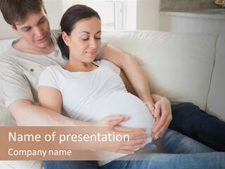 A Pregnant Couple Sitting On A Couch With Their Arms Around Each Other PowerPoint Template
