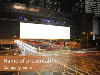 A City Street At Night With A Large Billboard In The Middle Of It PowerPoint Template