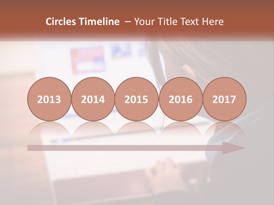 A Young Girl Is Looking At A Computer Screen PowerPoint Template