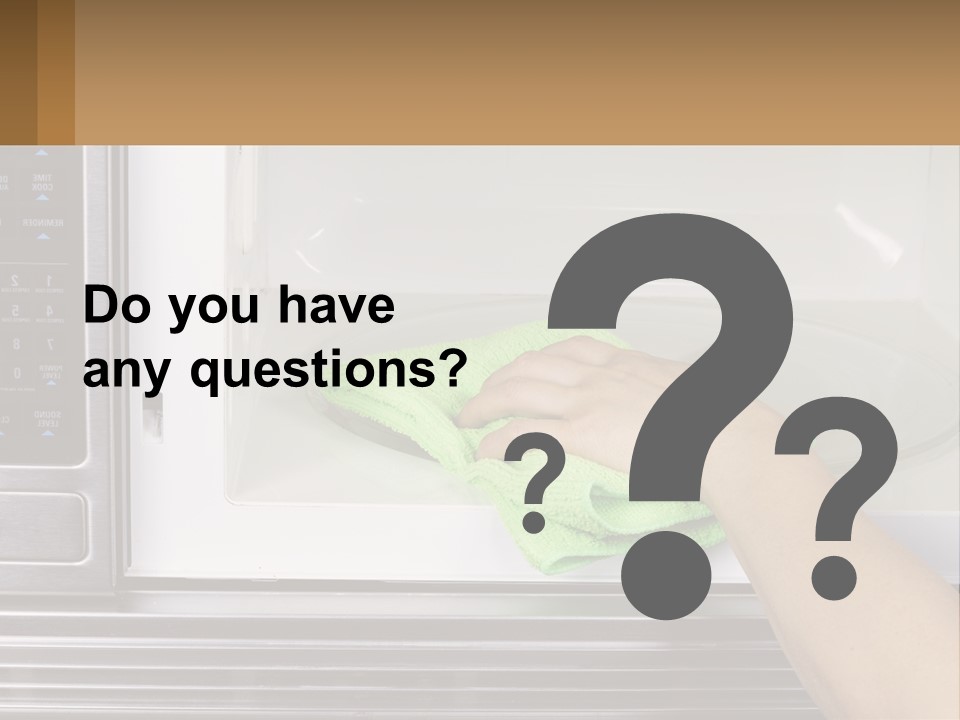 A Person Cleaning A Microwave With A Green Towel PowerPoint Template