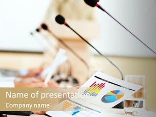 A Person Sitting At A Desk With Microphones In Front Of Them PowerPoint Template