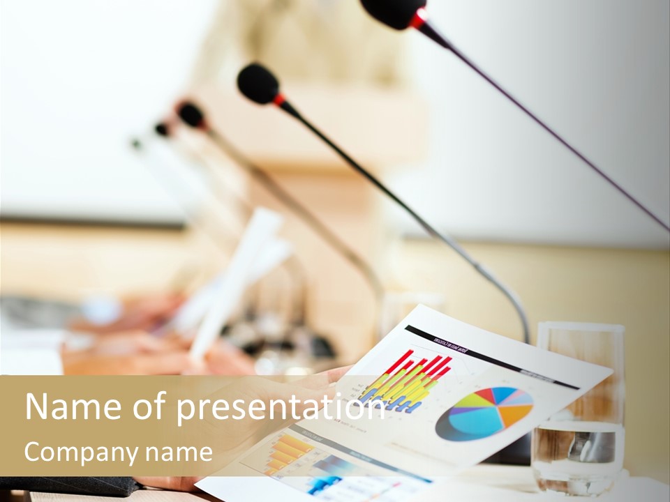 A Person Sitting At A Desk With Microphones In Front Of Them PowerPoint Template