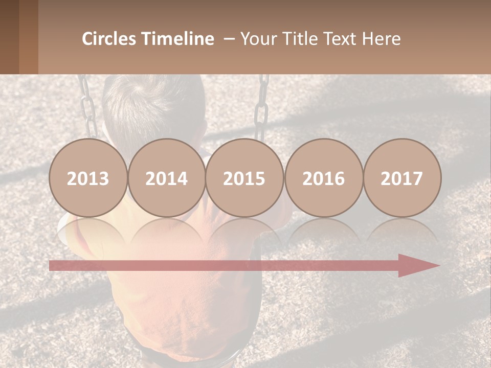 A Little Boy Sitting On A Swing In A Playground PowerPoint Template