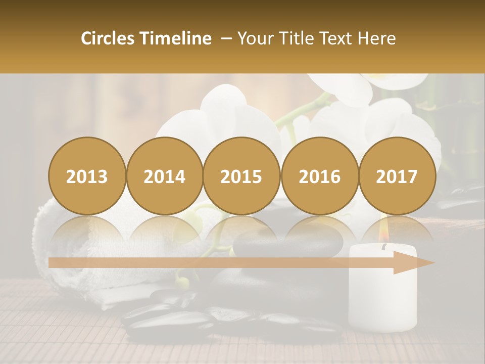 A White Candle And Some Black Rocks On A Table PowerPoint Template