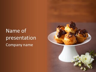 A Plate Of Pastries On A Table With Flowers PowerPoint Template