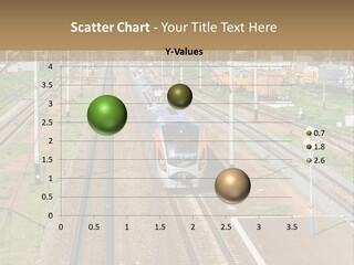 A Train Traveling Down Train Tracks Next To A Field PowerPoint Template