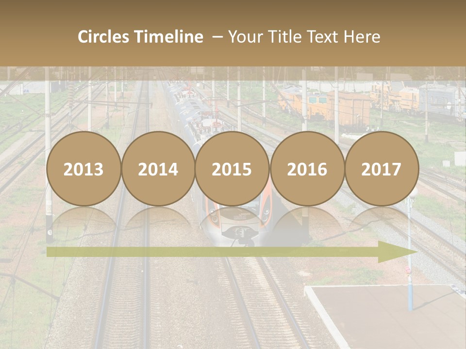 A Train Traveling Down Train Tracks Next To A Field PowerPoint Template