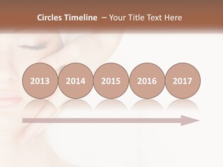 A Woman Getting A Facial Massage With A Towel On Her Head PowerPoint Template