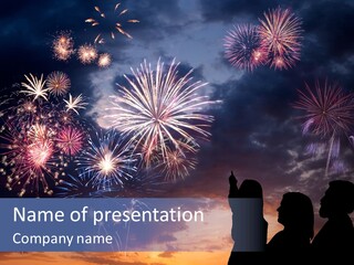 A Group Of People Watching Fireworks In The Sky PowerPoint Template