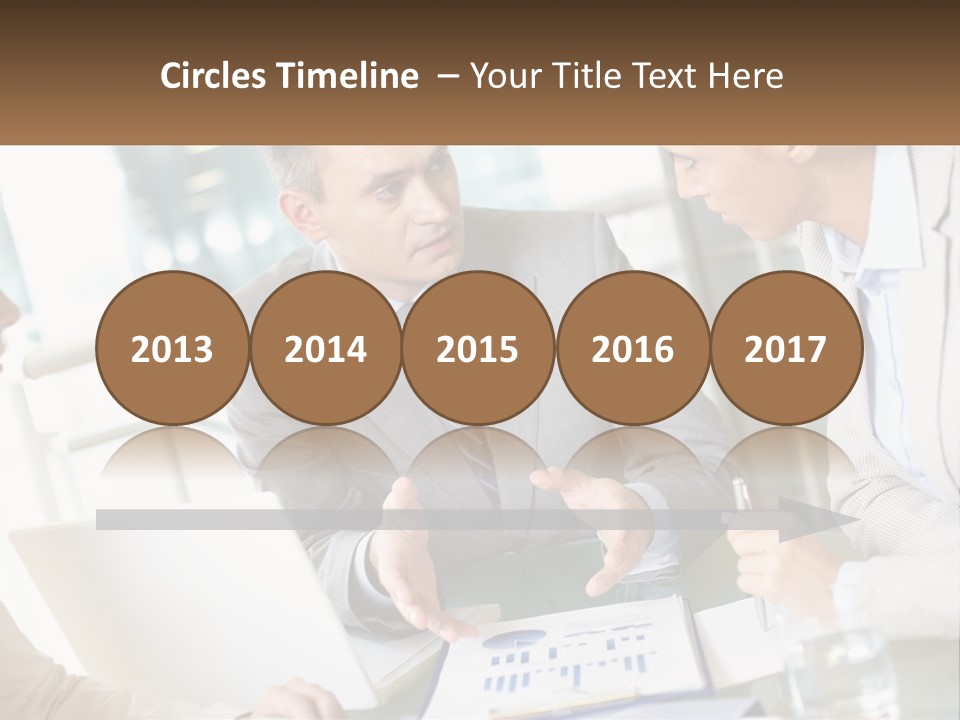 A Group Of People Sitting Around A Table Talking PowerPoint Template