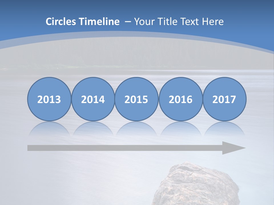 A Lake With Rocks In The Water And Mountains In The Background PowerPoint Template