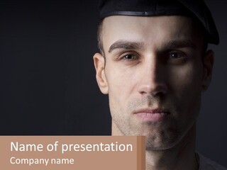 A Man In A Cap Is Looking At The Camera PowerPoint Template