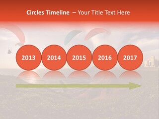 A Group Of Paraglides Flying Over A Body Of Water PowerPoint Template