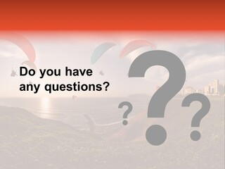 A Group Of Paraglides Flying Over A Body Of Water PowerPoint Template