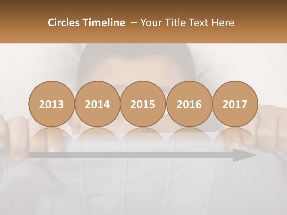 A Boy Peeking Over A Pillow With His Eyes Wide Open PowerPoint Template