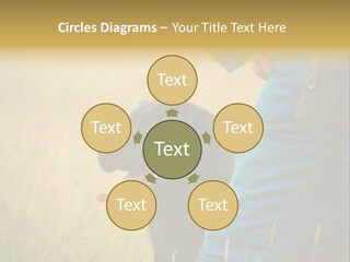 A Person Holding A Black Dog In A Field PowerPoint Template