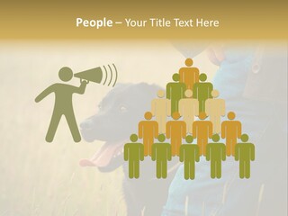 A Person Holding A Black Dog In A Field PowerPoint Template