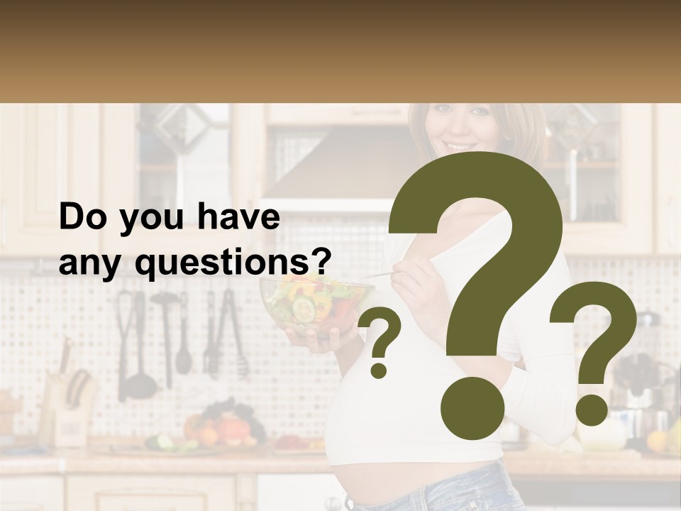 A Pregnant Woman Holding A Bowl Of Fruit In A Kitchen PowerPoint Template