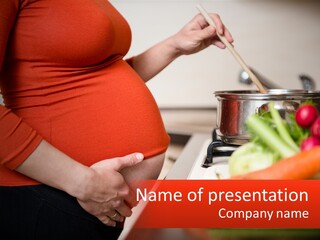 A Pregnant Woman Preparing Food In A Kitchen PowerPoint Template