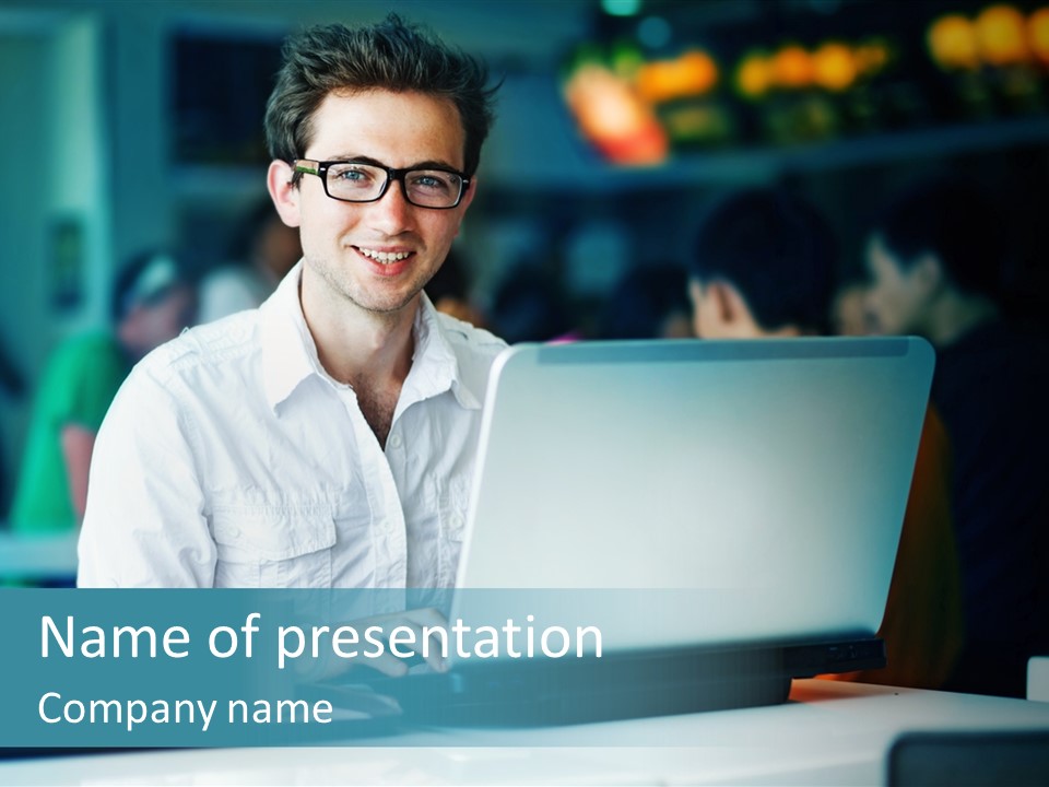 A Man Sitting In Front Of A Laptop Computer PowerPoint Template