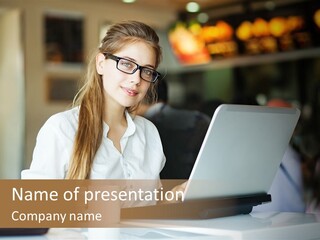 A Woman Sitting In Front Of A Laptop Computer PowerPoint Template