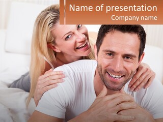 A Man And Woman Laying On A Bed Smiling PowerPoint Template