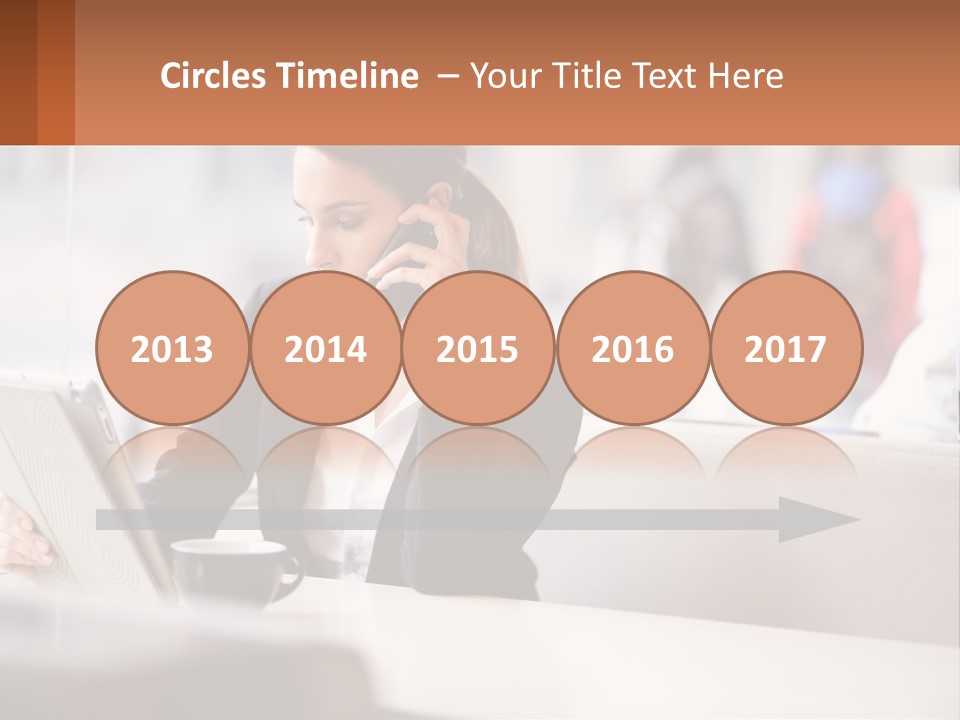 A Woman Talking On A Cell Phone While Using A Laptop PowerPoint Template