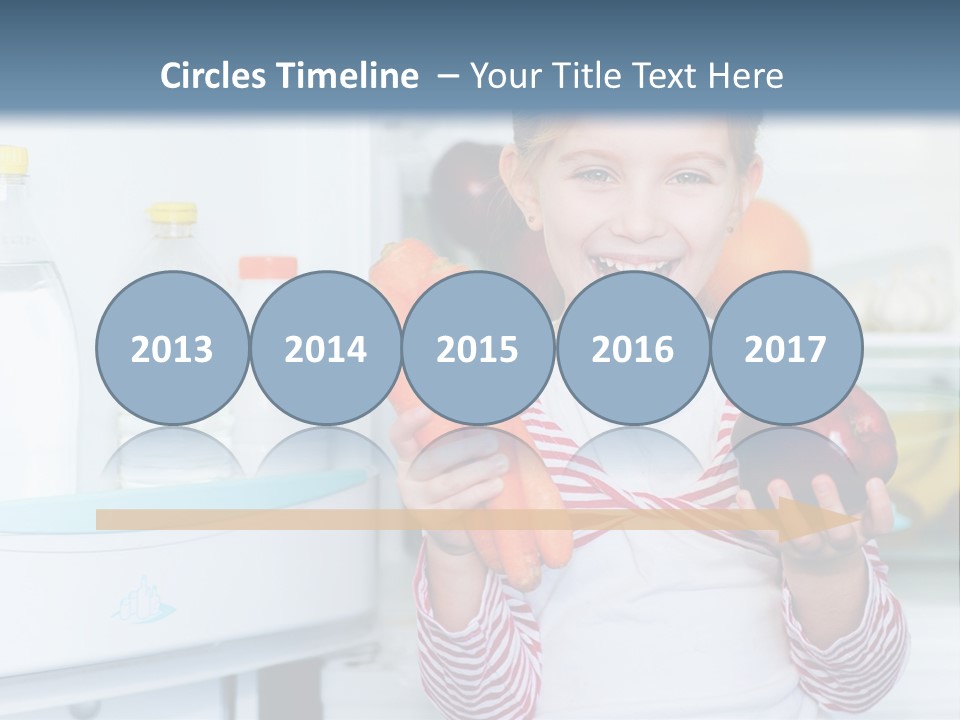 A Young Girl Holding Carrots And An Apple In Front Of A Refrigerator PowerPoint Template