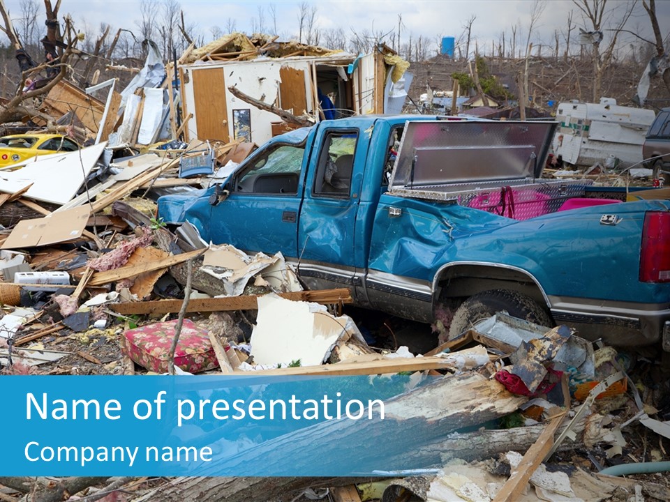 A Blue Truck Parked In A Pile Of Rubble PowerPoint Template